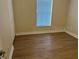 Bright bedroom with wood-look floors and a window with blinds at 21038 Voyager Blvd # 4, Land O Lakes, FL 34638