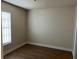 Simple bedroom with wood-look floors and a window with blinds at 21038 Voyager Blvd # 4, Land O Lakes, FL 34638