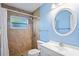 Updated bathroom with a walk-in shower and white vanity at 224 Sky Loch E Dr, Dunedin, FL 34698