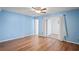 Spacious bedroom with light blue walls and wood-look floors at 224 Sky Loch E Dr, Dunedin, FL 34698