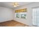 Bright bedroom with two windows and wood-look floors at 224 Sky Loch E Dr, Dunedin, FL 34698