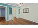 Bright dining area with wood-look floors and built-in shelving at 224 Sky Loch E Dr, Dunedin, FL 34698