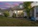 Exterior view at dusk showing landscaping and a light blue door at 224 Sky Loch E Dr, Dunedin, FL 34698
