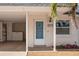 Front door entrance to condo, with carport and landscaping visible at 224 Sky Loch E Dr, Dunedin, FL 34698