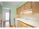 Kitchen features light wood cabinets and white appliances at 224 Sky Loch E Dr, Dunedin, FL 34698