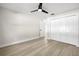 Well-lit bedroom with ceiling fan, wood flooring, and closet at 2516 Ridgetop Way, Valrico, FL 33594