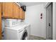 Convenient laundry room with washer, dryer, and overhead cabinets at 2705 Lakeville Dr, Tampa, FL 33618