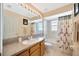 Bathroom with tub, shower, and patterned curtain at 2852 Banyan Hill Ln, Land O Lakes, FL 34639