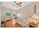 Bedroom with wood floor, dresser, and bed at 2852 Banyan Hill Ln, Land O Lakes, FL 34639