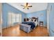 Serene bedroom with light blue walls and a ceiling fan at 2852 Banyan Hill Ln, Land O Lakes, FL 34639