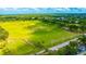 Aerial view of a driving range with people practicing at 2852 Banyan Hill Ln, Land O Lakes, FL 34639