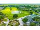 Aerial view of golf course, clubhouse, and landscaping at 2852 Banyan Hill Ln, Land O Lakes, FL 34639