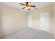 Simple bedroom with ceiling fan and neutral walls at 30129 Mossbank Dr, Wesley Chapel, FL 33543