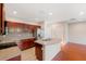 Kitchen with dark wood cabinets, an island, and stainless steel appliances at 30129 Mossbank Dr, Wesley Chapel, FL 33543