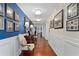 Bright hallway with hardwood floors and framed Gathering photos at 3301 Bayshore Blvd # 1908B, Tampa, FL 33629