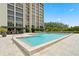 Resort-style pool with surrounding lounge chairs and building view at 3301 Bayshore Blvd # 1908B, Tampa, FL 33629