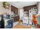 Small kitchen featuring dark brown cabinets and white appliances at 3436 51St N Ave, St Petersburg, FL 33714