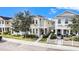 Two-story townhome with light-colored siding, white picket fence, and landscaping at 3465 Bumelia Ln, New Port Richey, FL 34655