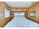 Main bedroom with a floral comforter and built-in wooden cabinets at 35216 Dodie Dr, Zephyrhills, FL 33541