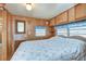 Main bedroom with a floral comforter and an exterior door at 35216 Dodie Dr, Zephyrhills, FL 33541