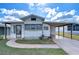 White single-wide manufactured home with carport and landscaped yard at 35216 Dodie Dr, Zephyrhills, FL 33541