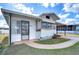 Front view of a white manufactured home with a covered carport at 35216 Dodie Dr, Zephyrhills, FL 33541