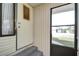 Front entrance with storm door and steps leading to the home at 35216 Dodie Dr, Zephyrhills, FL 33541