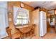 Small kitchen nook with wood table and chairs, and a white refrigerator at 35216 Dodie Dr, Zephyrhills, FL 33541