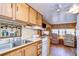 Open kitchen with wood cabinets, and a view of the living area at 35216 Dodie Dr, Zephyrhills, FL 33541