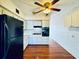 Kitchen with white cabinets, black appliances, and wood flooring at 4300 58Th N St # 2005, Kenneth City, FL 33709