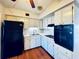 Efficient kitchen featuring white cabinets and black appliances at 4300 58Th N St # 2005, Kenneth City, FL 33709