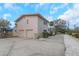 Two-car garage and side view of a pink house at 6600 Mango S Ave, St Petersburg, FL 33707