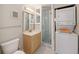 Small bathroom with shower and laundry at 7540 Sunshine Skyway S Ln # 220, St Petersburg, FL 33711