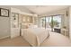 Bright bedroom with a balcony overlooking the beach, built-in shelving, and a comfortable bed at 7540 Sunshine Skyway S Ln # 220, St Petersburg, FL 33711