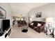 Bright living room featuring vaulted ceiling, neutral carpet, and views to dining area at 7540 Sunshine Skyway S Ln # 220, St Petersburg, FL 33711