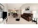 Inviting living room with vaulted ceilings, leather furniture, and an open floor plan to the dining area at 7540 Sunshine Skyway S Ln # 220, St Petersburg, FL 33711