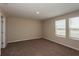 Well-lit bedroom with carpeted floor and neutral wall colors at 7685 Peace Lily Ave, Wesley Chapel, FL 33545