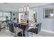 Dining area with a glass table and chairs, adjacent to kitchen at 8134 Bayshore Dr, Seminole, FL 33776