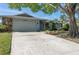 Spacious driveway leading to a light-blue house with a stone facade at 8134 Bayshore Dr, Seminole, FL 33776