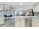 Open concept kitchen with bar seating overlooking living and dining areas at 8134 Bayshore Dr, Seminole, FL 33776