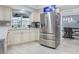 Spacious kitchen boasts stainless steel refrigerator, ample cabinetry, and natural light at 8134 Bayshore Dr, Seminole, FL 33776