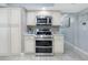 Modern kitchen features stainless steel appliances, light cabinetry, and tile backsplash at 8134 Bayshore Dr, Seminole, FL 33776