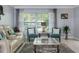 Well-lit living room with neutral tones, a comfortable sofa, and a stylish coffee table at 8134 Bayshore Dr, Seminole, FL 33776