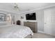 Main bedroom with mounted TV and dresser at 8134 Bayshore Dr, Seminole, FL 33776