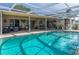 Inviting screened-in pool with spacious patio and outdoor seating at 8134 Bayshore Dr, Seminole, FL 33776