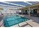 Large pool area with outdoor seating and dining, perfect for entertaining guests at 8134 Bayshore Dr, Seminole, FL 33776