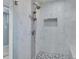 Large walk-in shower with multiple shower heads and pebble floor at 8134 Bayshore Dr, Seminole, FL 33776