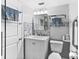 Clean bathroom, featuring a walk-in shower, new vanity, and tile flooring at 10449 Larchmont N Pl, Pinellas Park, FL 33782
