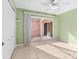 Light and airy bedroom with tile floors and access to a private patio at 10449 Larchmont N Pl, Pinellas Park, FL 33782