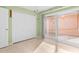 Bedroom with tile floors, double-door closet and patio access at 10449 Larchmont N Pl, Pinellas Park, FL 33782
